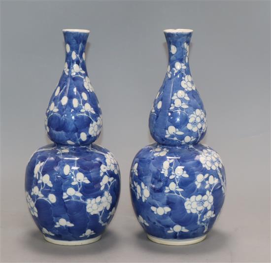 A pair of 19th century Chinese blue and white double gourd vases, Kangxi mark height 25cm